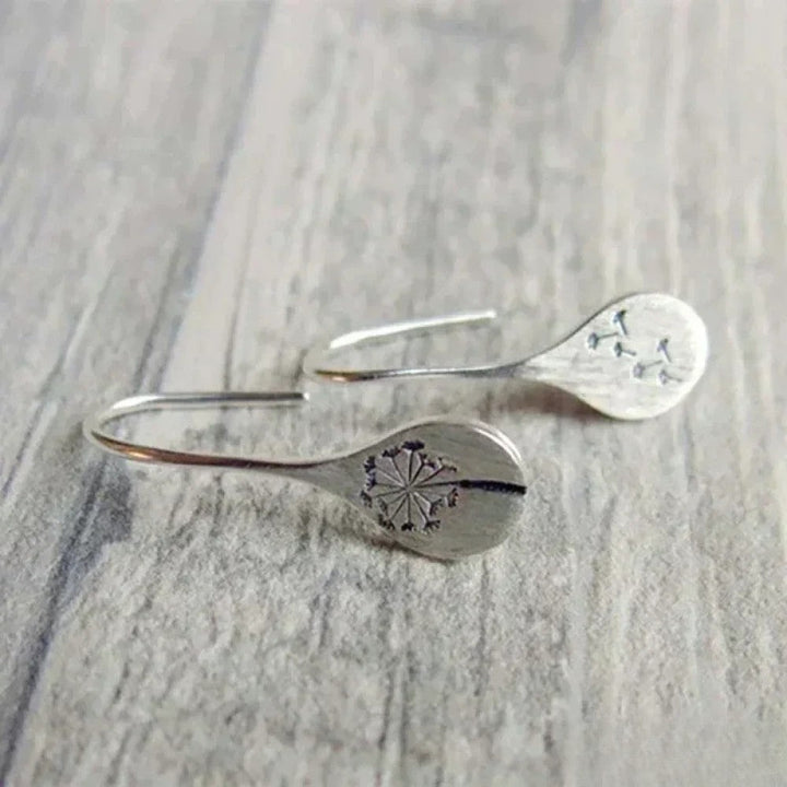 Tyylikkäät toivon korvakorut voikukka-leväaiheella